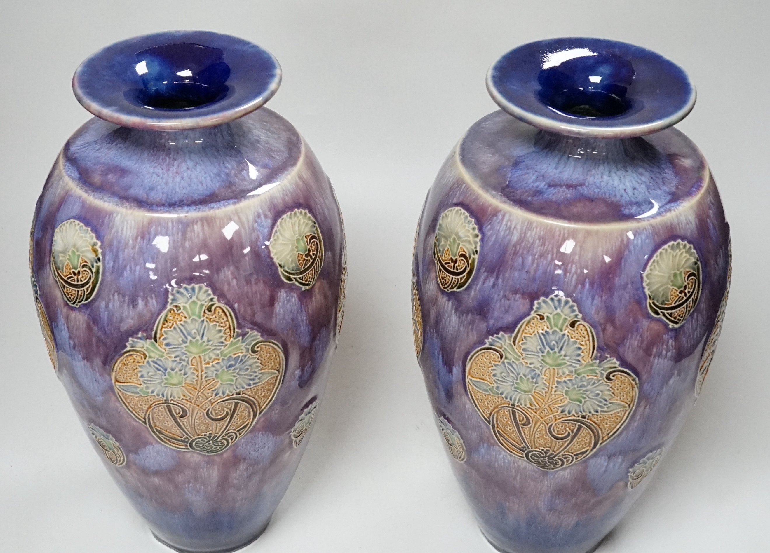 A pair of Doulton stoneware vases by Florie Jones, 31cm